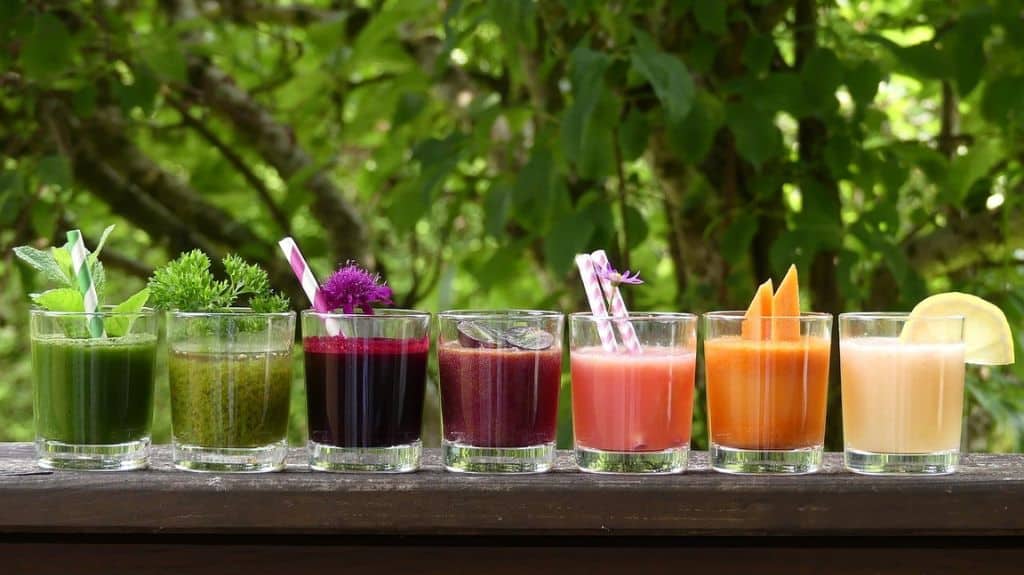 Line of smoothies in different colors like a rainbow