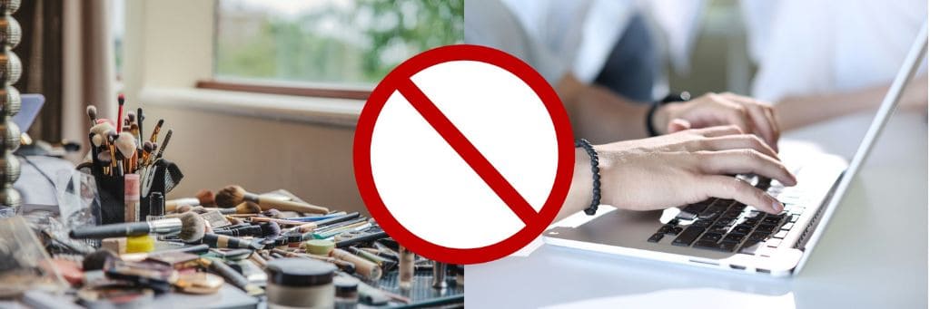 Makeup on desk, someone typing on laptop, and "cancel" sign