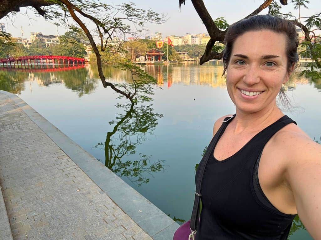 Heidi, the author, posing in front of Kiem lake with red bridge in the background