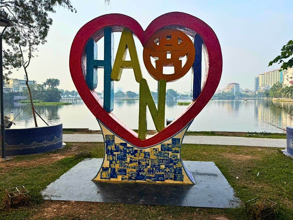 Hanoi sign by the waterfront showing a heart with the Hanoi letters inside