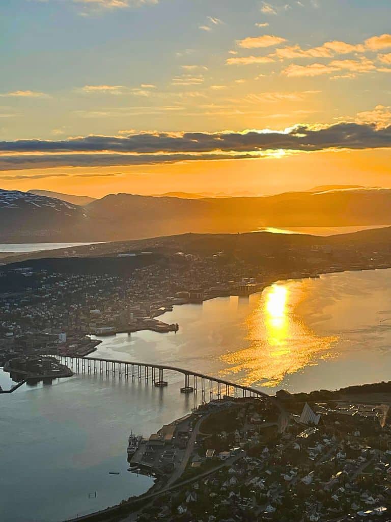 View from above of downtown Tromso, the bridge, the fjords, mountains, and the sunset of the Midnight Sun