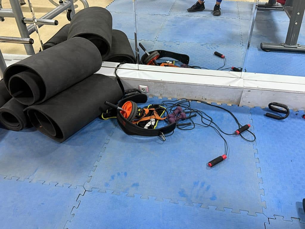 Goreme Fitness Center gym's accessories, dirty cushioned mat, and yoga mats