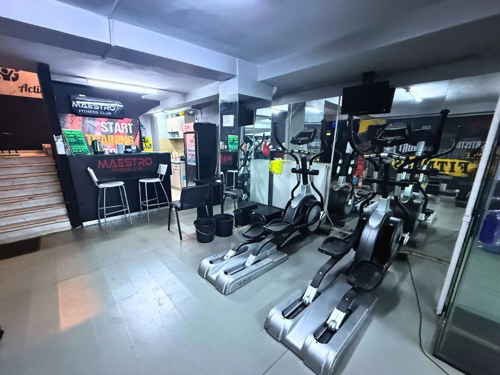 Two ellipticals and front desk of the gym