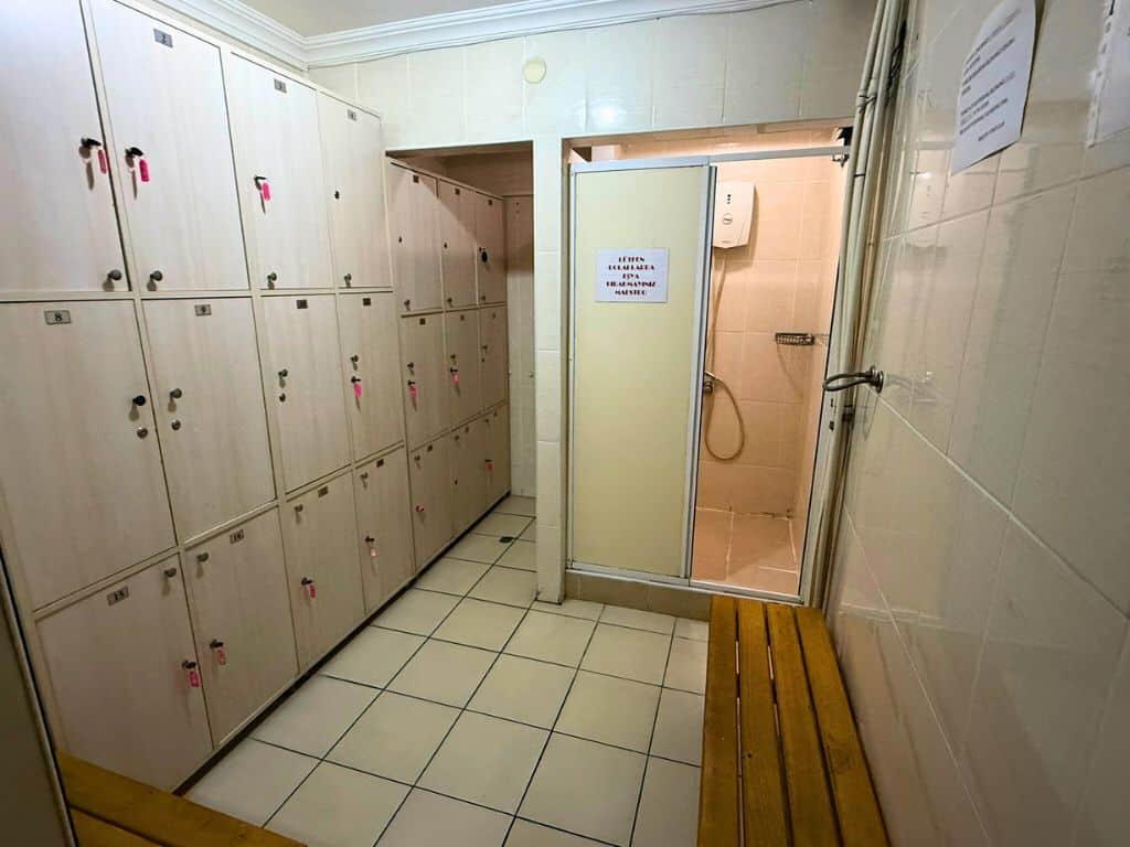 Locker room with lockers, shower, and benches