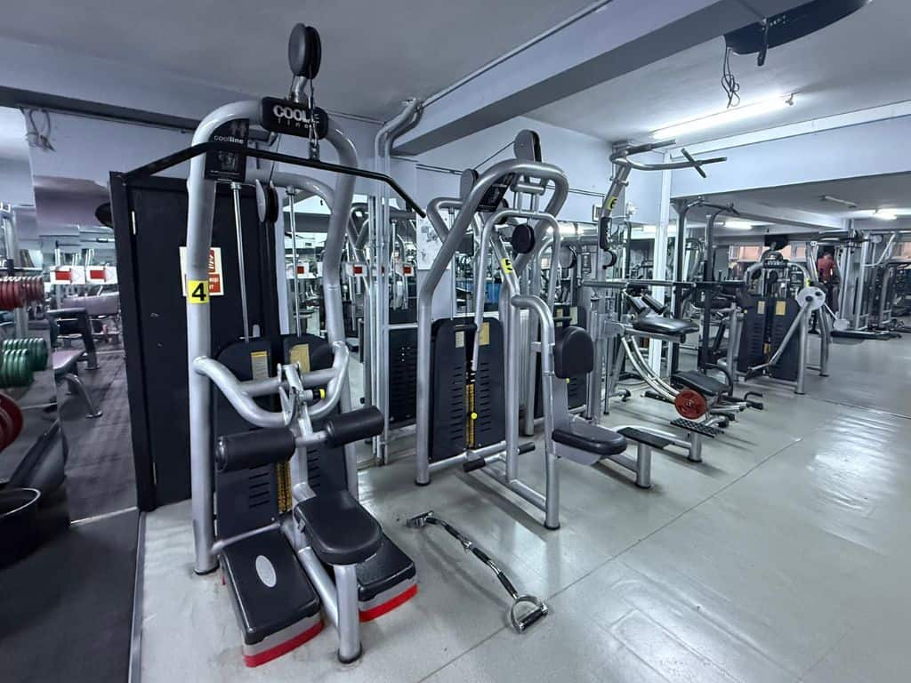 Various weight machines including lat pull down