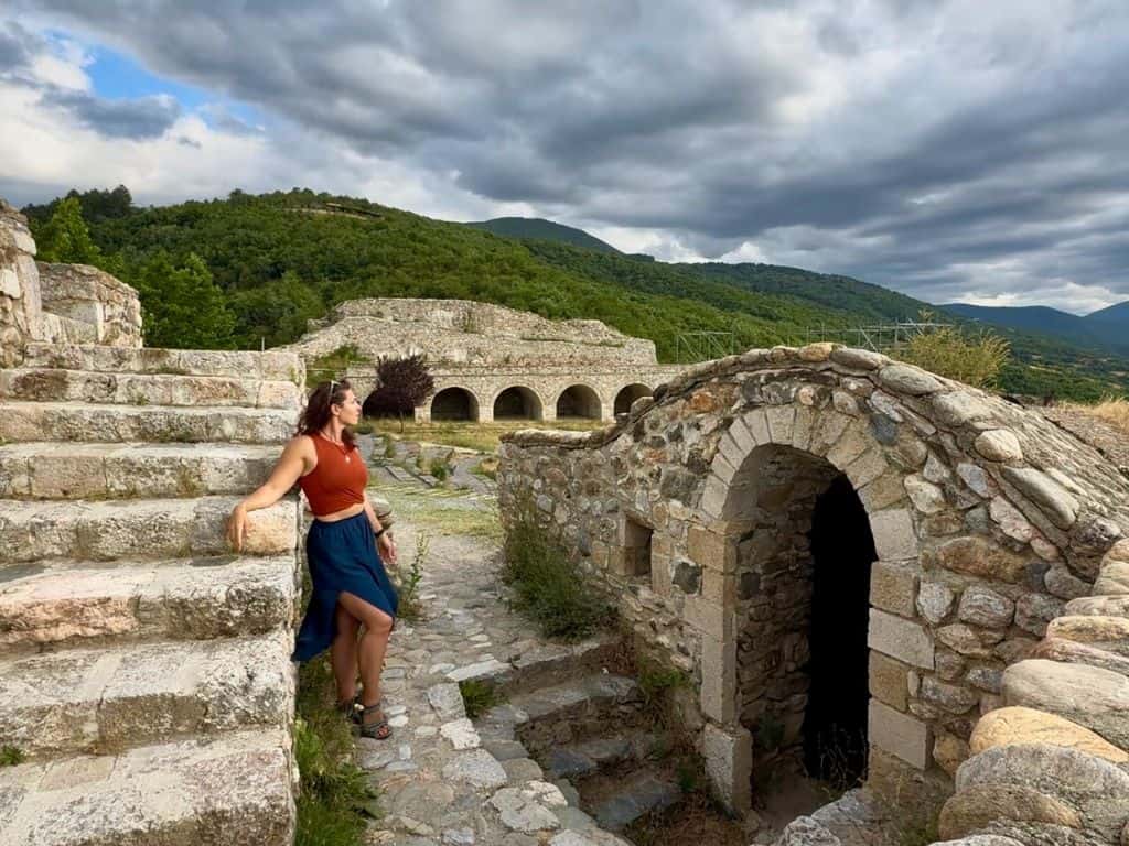 Traveler posing alone in front of old ruins in Prizren, Kosovo