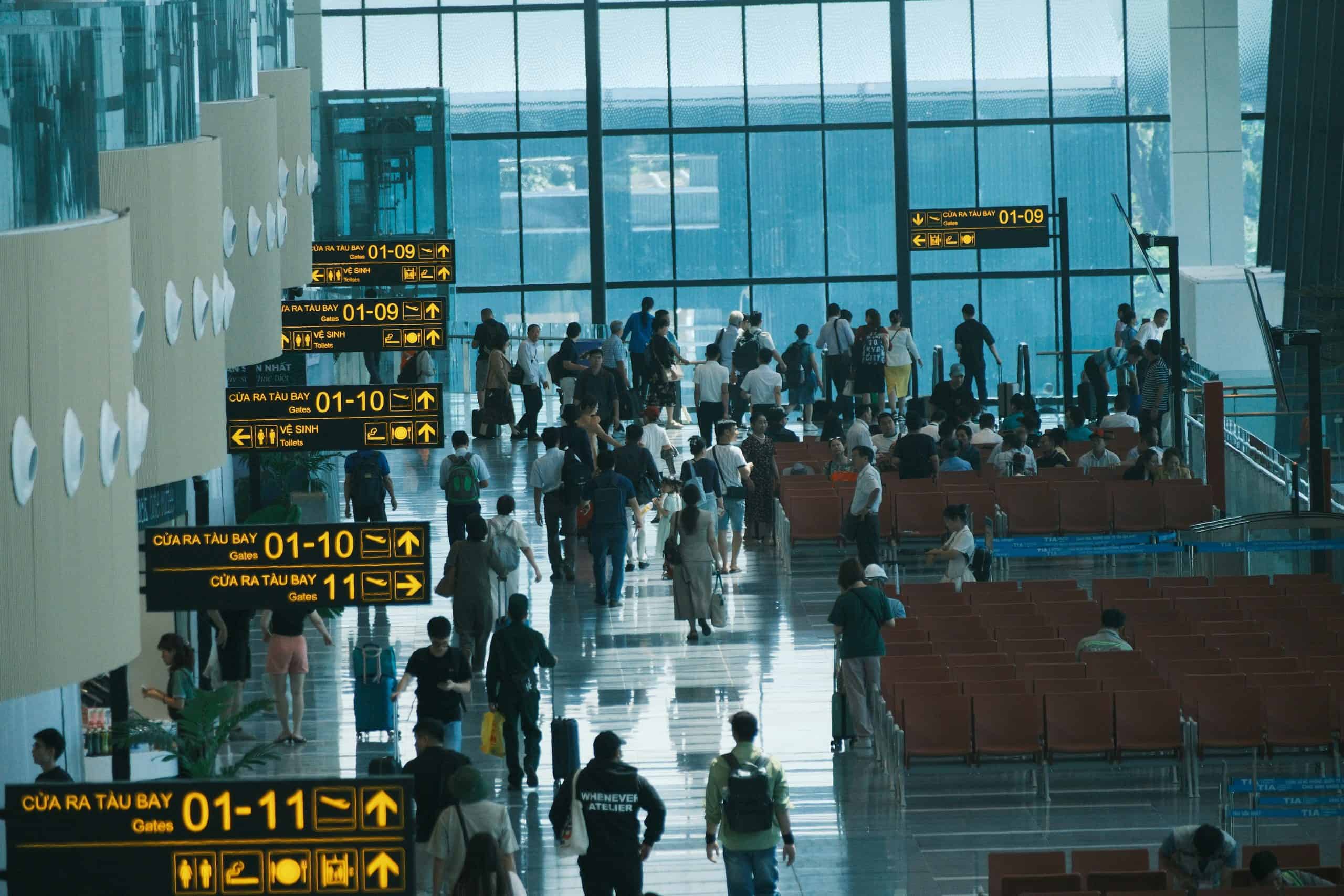 View from above of an airport terminal with people and airport signage