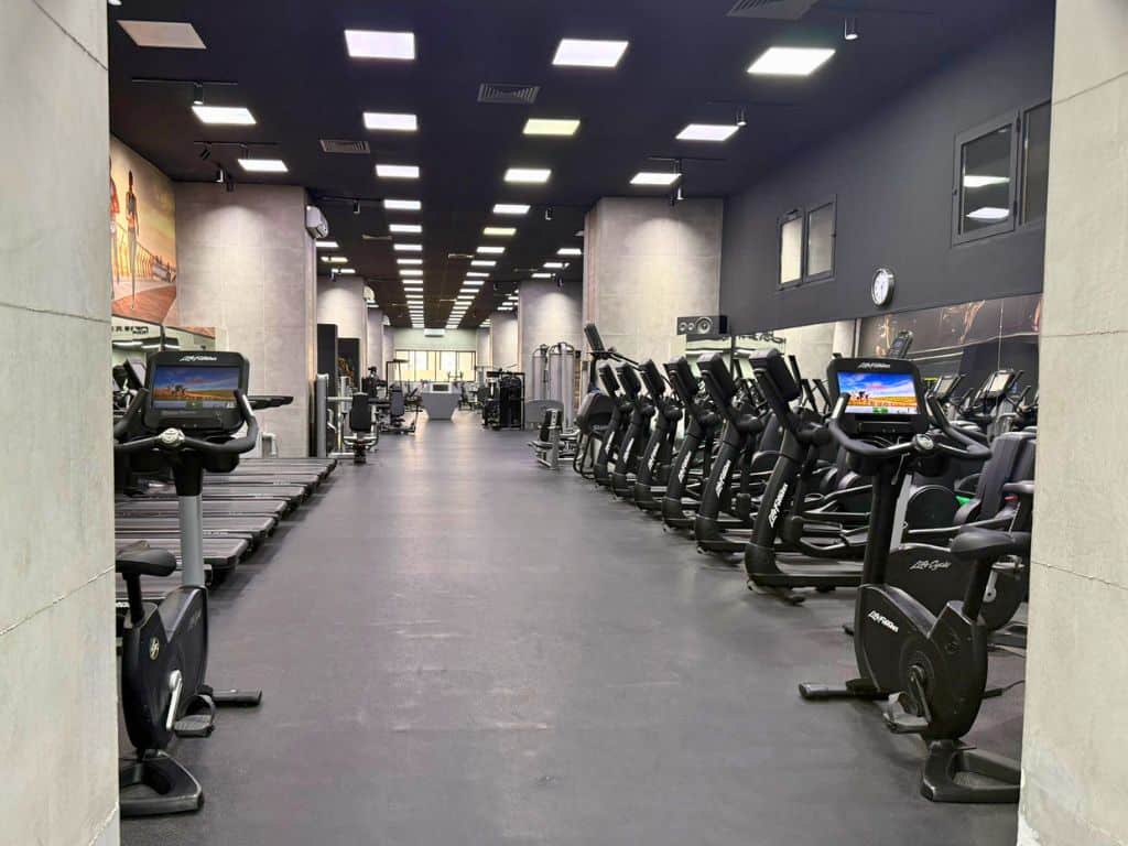 First zone in the gym with rows of cardio equipment
