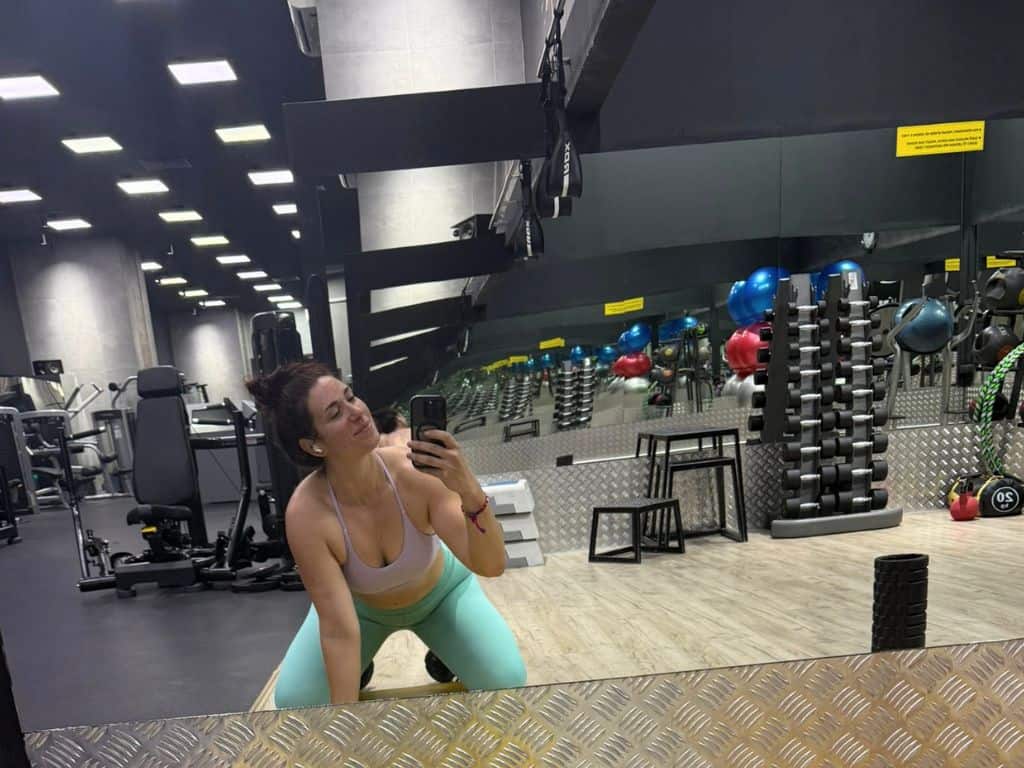 Heidi, author, posing in front of mirror in studio section of the gym
