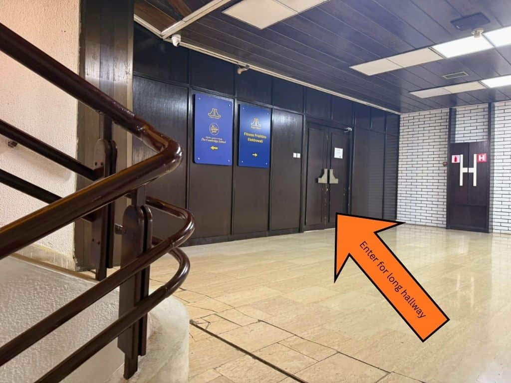 Orange arrow pointing to the double doors to enter the next hallway